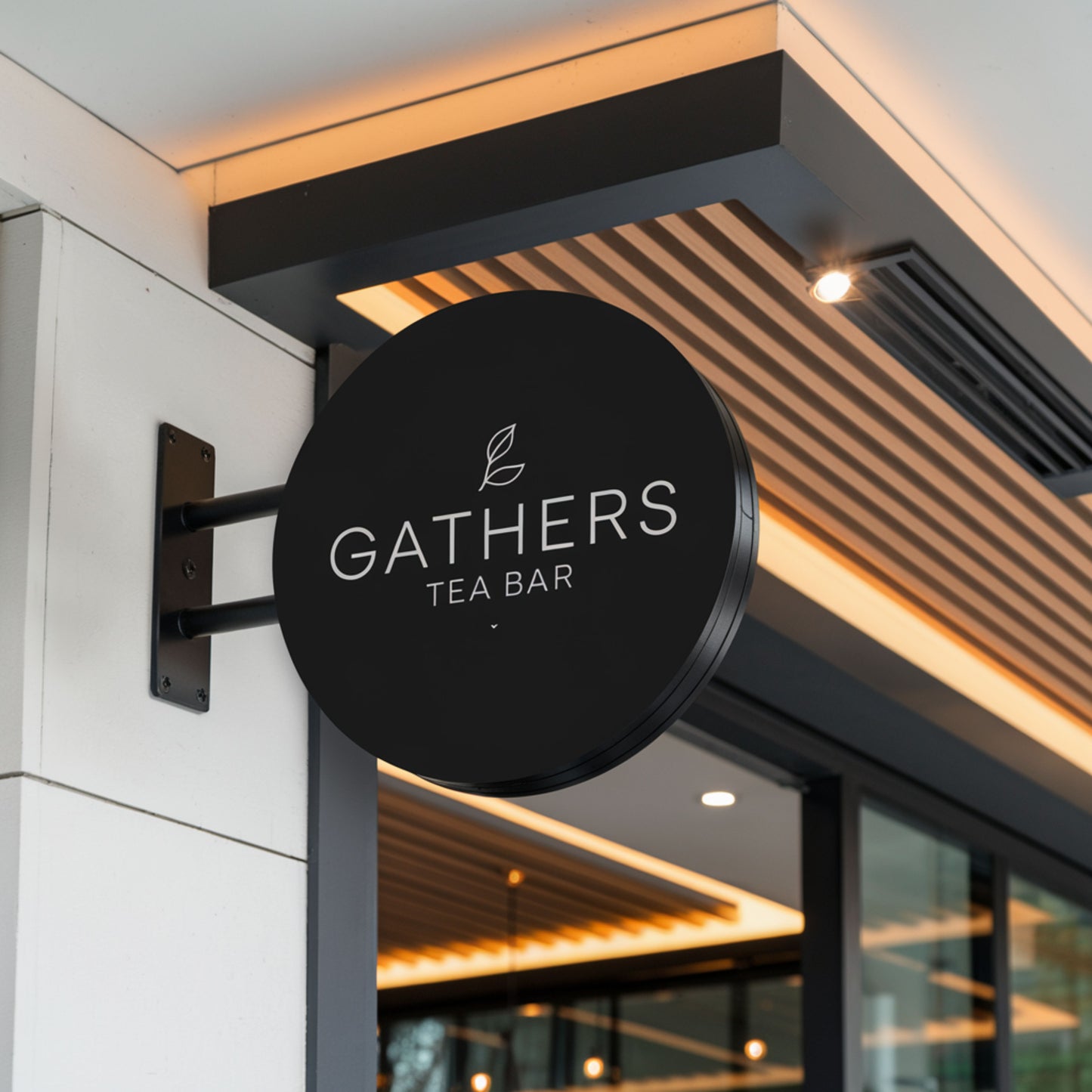 Black sign with 'Gathers Tea Bar' logo on a building exterior
